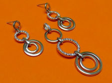 Picture of “Perfect circles” set of pendant and dangle earrings in sterling silver, an alternation of plain silver circles and circles inlaid with round cubic zirconia