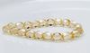 Picture of 6x6 mm, Czech faceted round beads, transparent, champagne beige luster