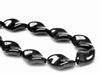 Picture of 19x13 mm, Czech druk beads, twisted leaf, black, opaque, glossy finishing, 12 pieces